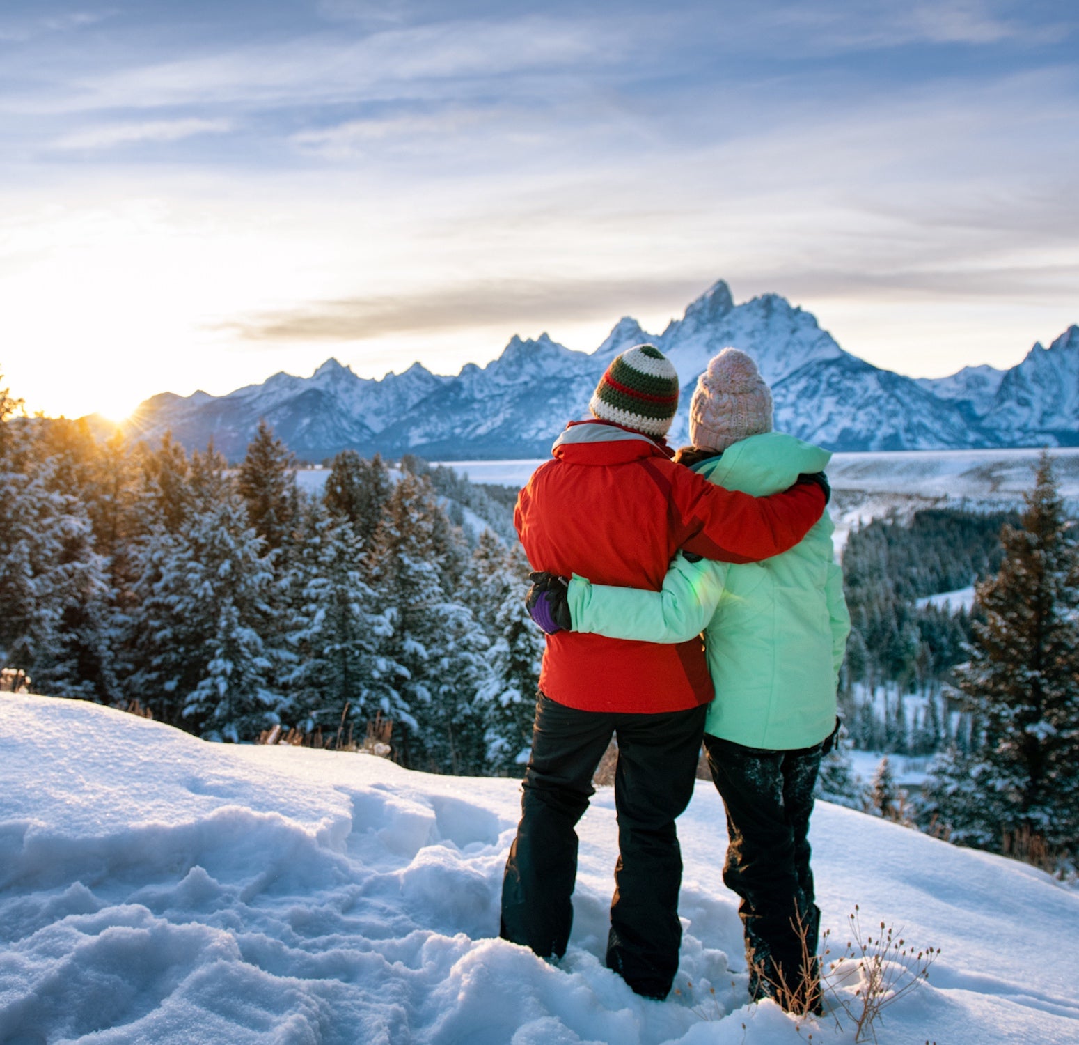 mom and daughter on snowy mountain