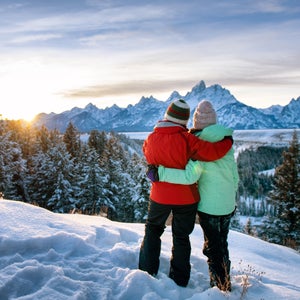 mom and daughter on snowy mountain