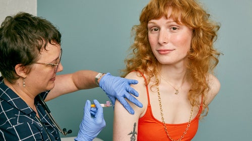 Woman receiving a vaccine in a doctor's office