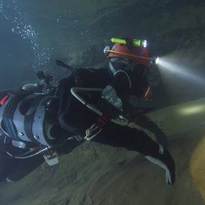 Diver in cave with headlamp