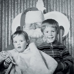 The author and her brother, Chris Ross, with Santa in 1972