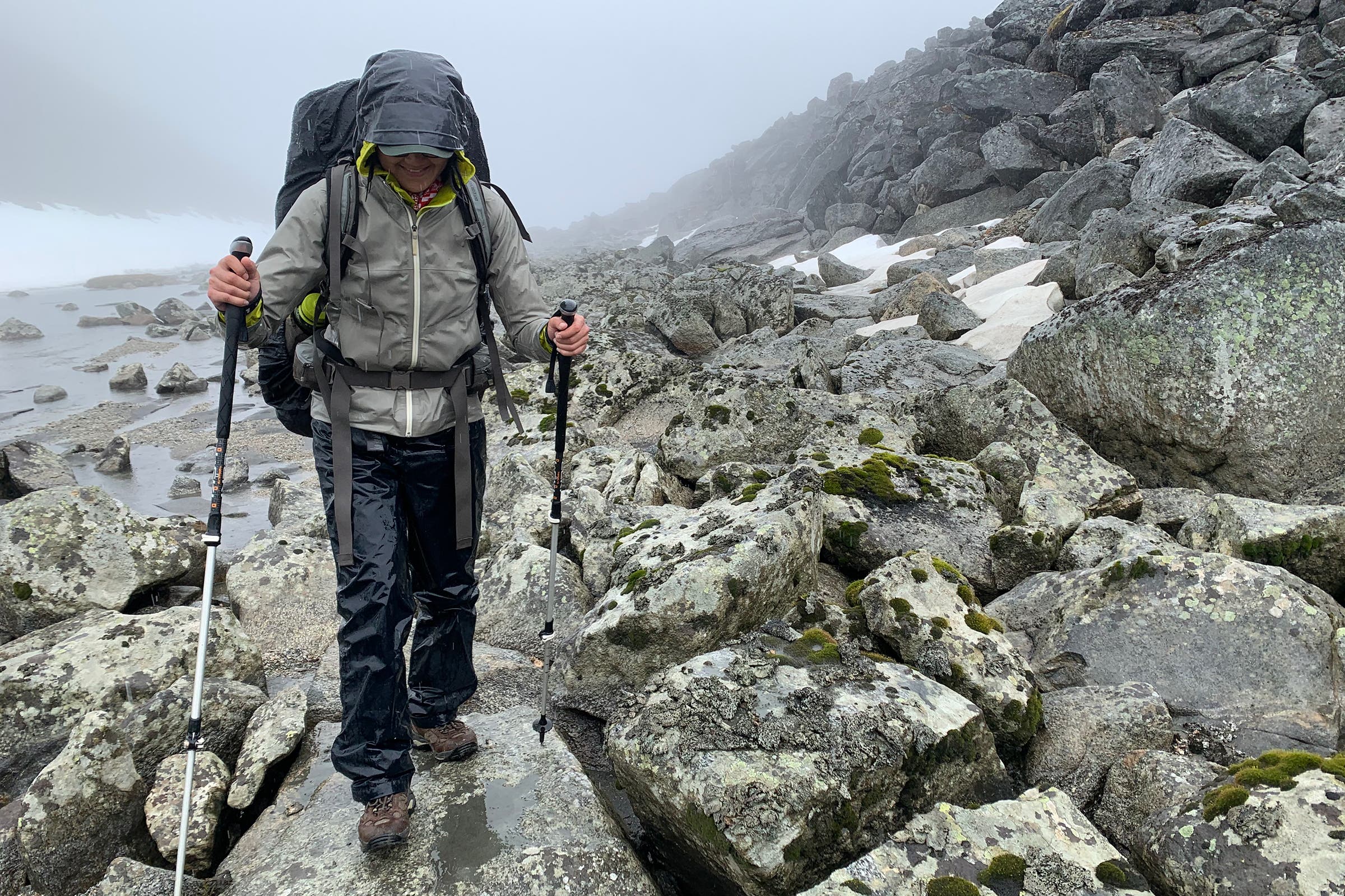 Jessica hiking over slick boulders