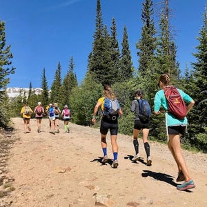 Girls running up a mountain.