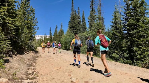 Girls running up a mountain.