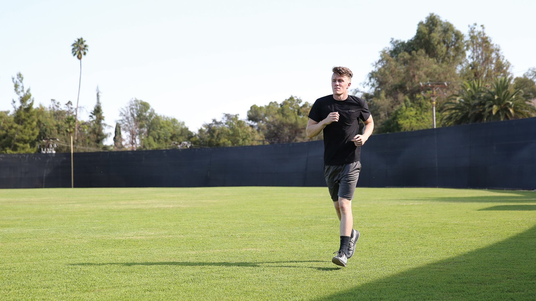 Man jogging on grassy turf