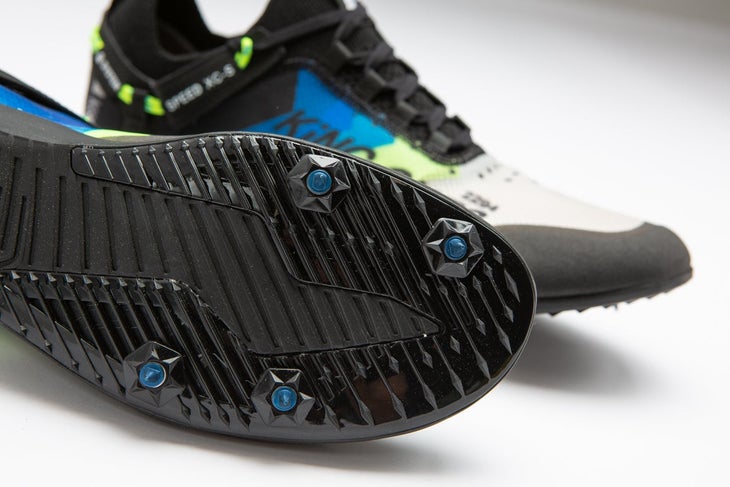 Skechers xc5 cross country running spike in profile. black, blue, and white. Showing bottom of shoe with spikes.