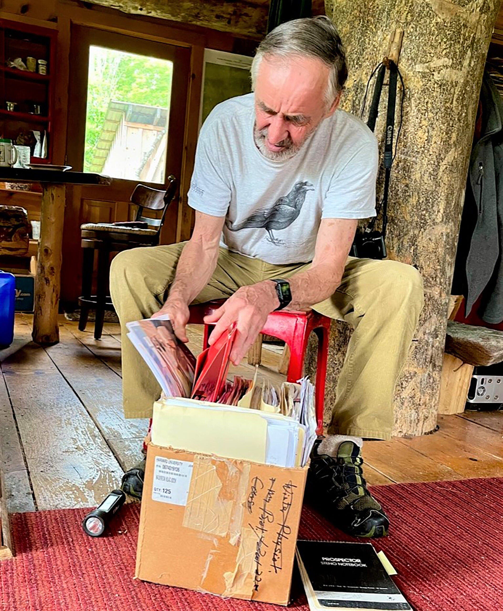 Bernd Heinrich digging into a box of documents