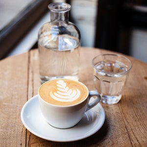 Cup of cappuccino on the table in a coffee shop