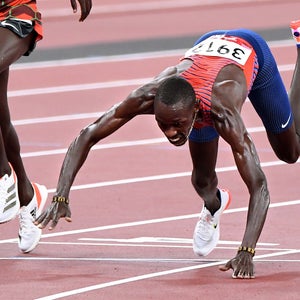 USAs Paul Chelimo falls across the finish line to win the bronze medal in the mens 5000m race at the 2020 Tokyo Olympics.