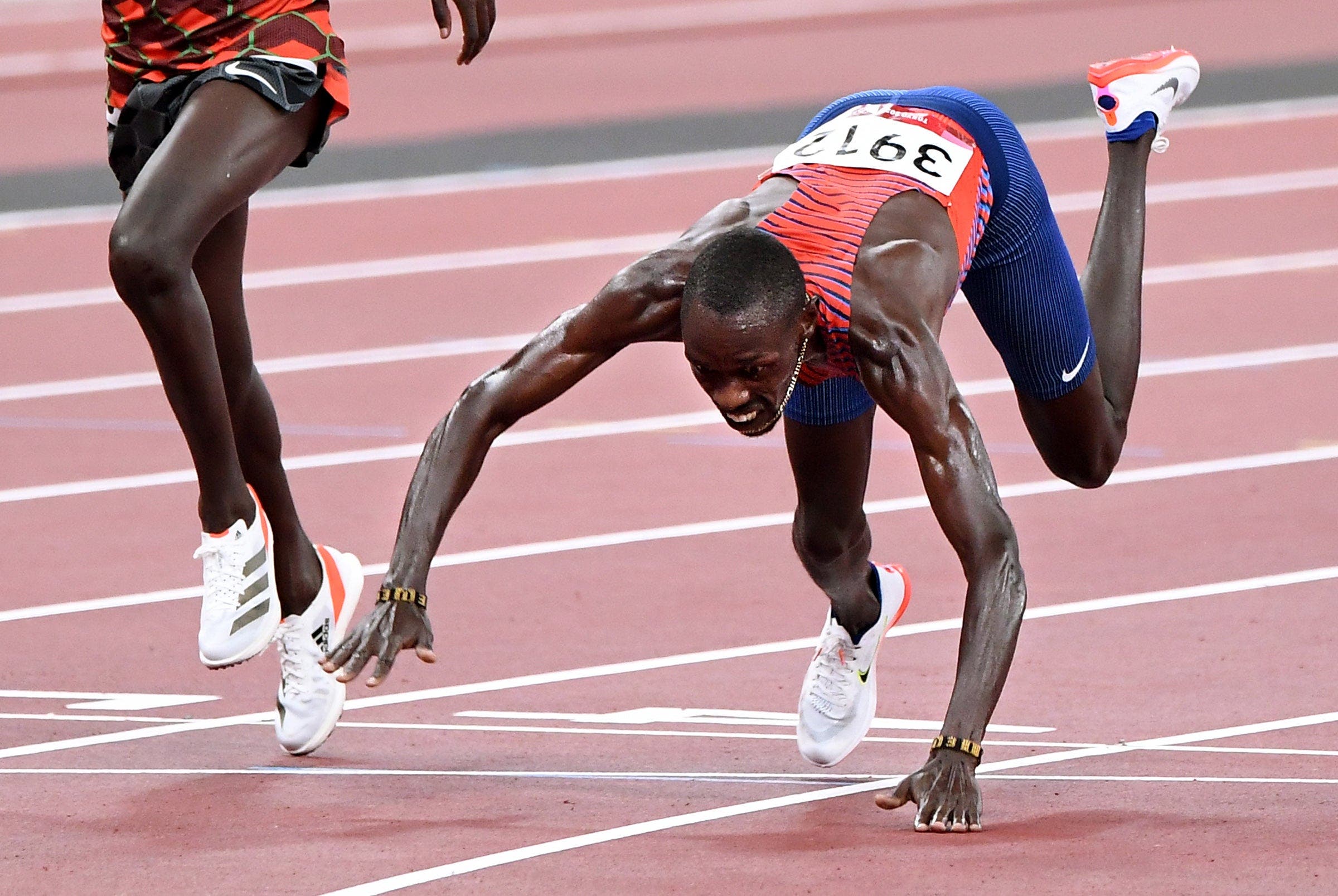 USAs Paul Chelimo falls across the finish line to win the bronze medal in the mens 5000m race at the 2020 Tokyo Olympics.