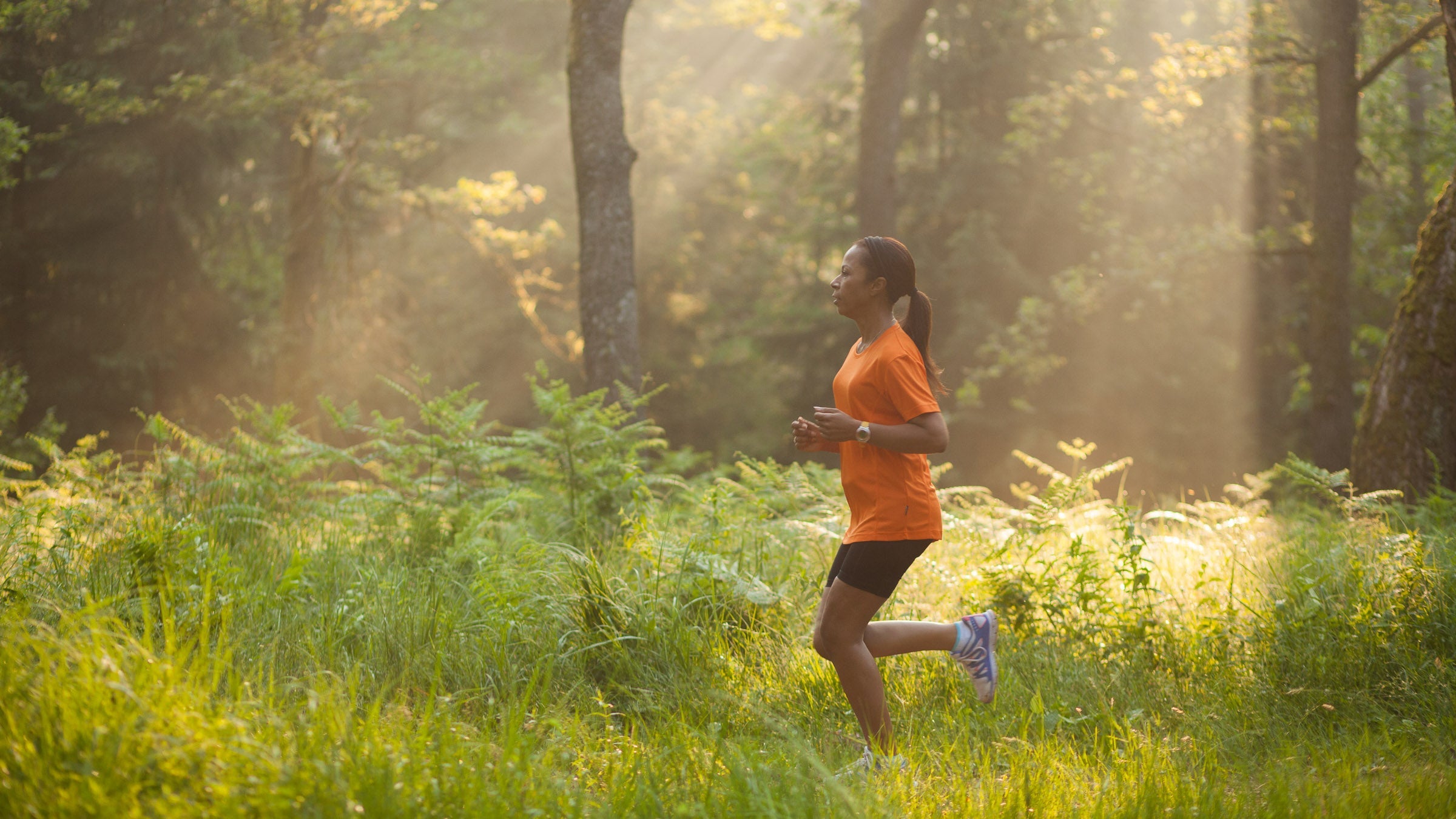 Woman running through woods