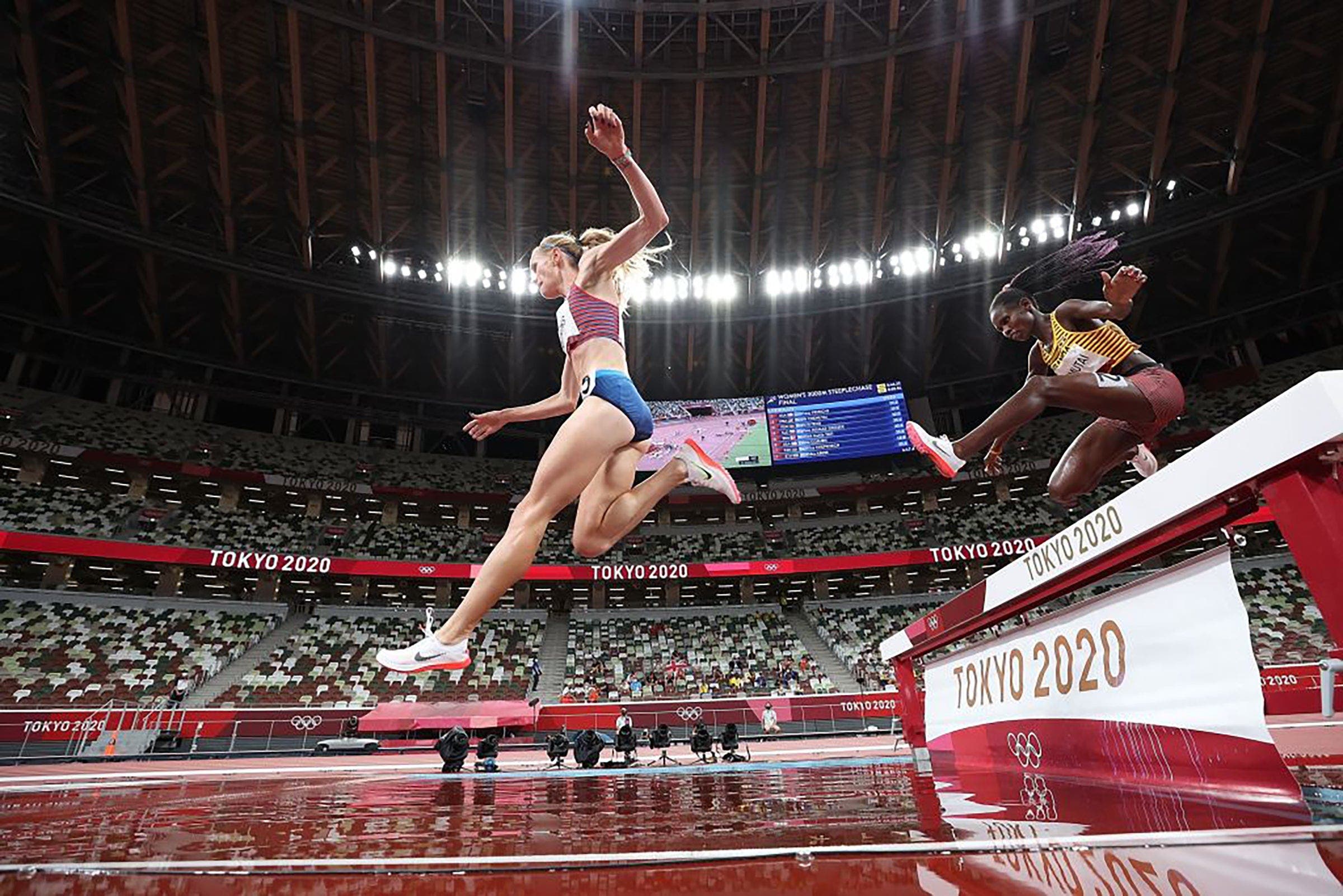 Courtney Frerichs leads Peruth Chemutai during the women's 3000m steeplechase final at Tokyo 2020 Olympic Games, in Tokyo, Japan, Aug. 4, 2021.
