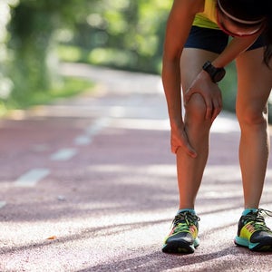 Female runner suffering from shin splints injury.