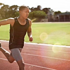 Shot of a young athlete out running on the track.