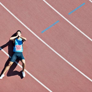 Tired runner laying on track.