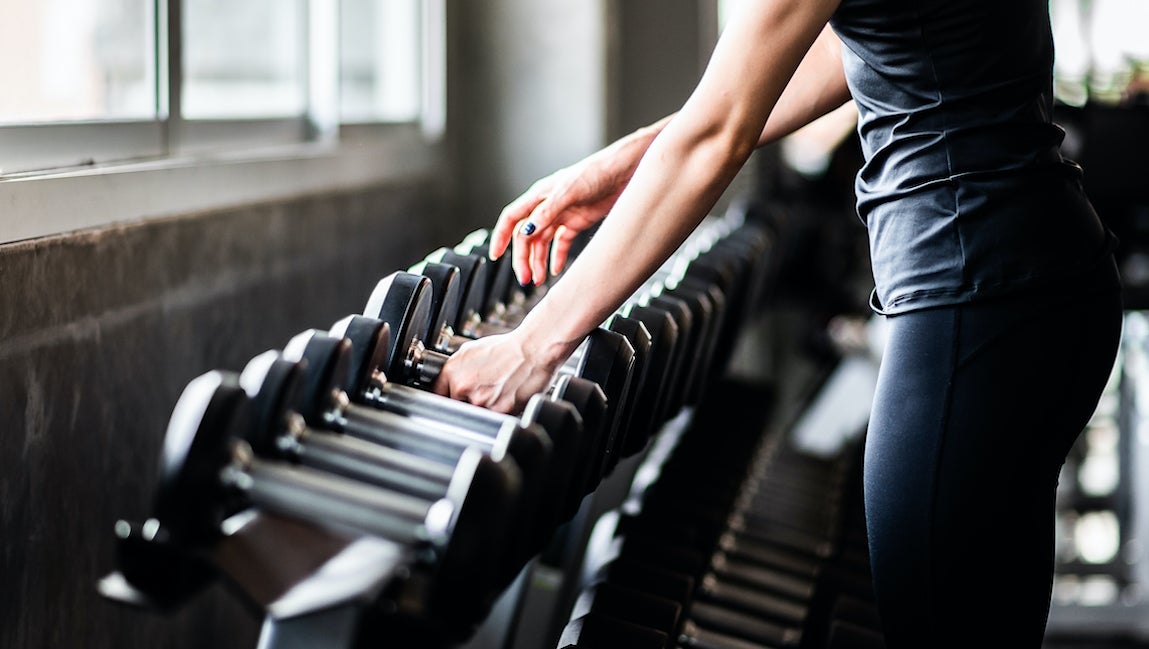 Premium Photo  A young woman using fitness dumbbells for exercise