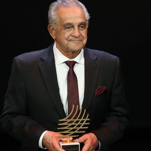 Joe Vigil with award in hand.