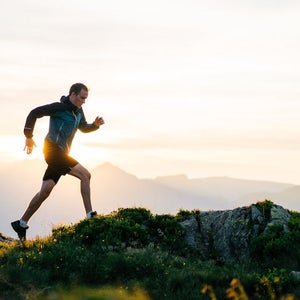 Runner running on a mountain at sunrise.
