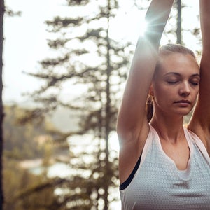 Close up of a young lady breathing in the forest.
