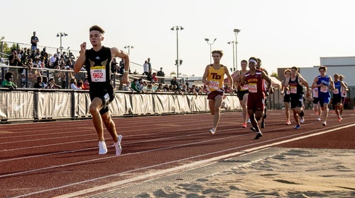High school boys racing at track meet in California.