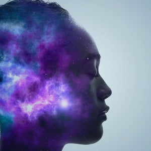 Woman in meditation with galaxy in head.