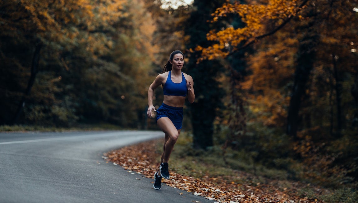 Woman running outdoors in the fall.
