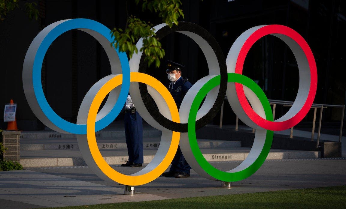 A security worker stands next to the Olympic Rings during a protest against the Tokyo Olympics on May 09, 2021 in Tokyo, Japan. With less than 3 months remaining until the Tokyo 2020 Olympics concern continues to linger in Japan over the feasibility of hosting such a huge event during the ongoing COVID-19 pandemic.