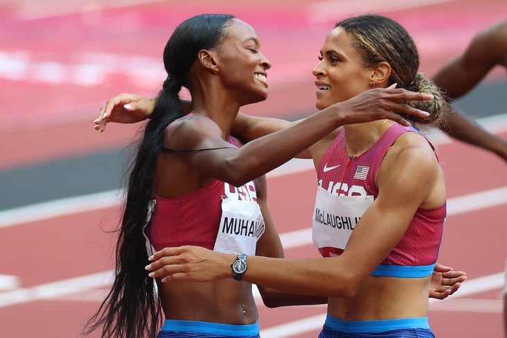 Teammates Dalilah Muhammad of Team United States and Sydney McLaughlin hug after winning silver and gold in the Women's 400m Hurdles Final on day twelve of the Tokyo 2020 Olympic Games.