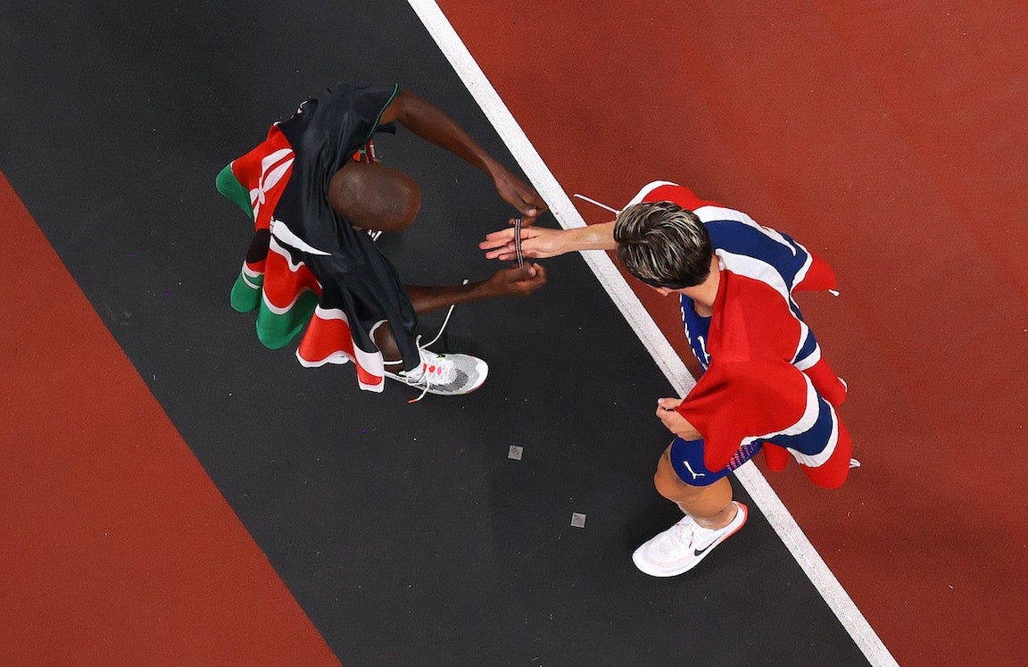 Timothy Cheruiyot gifting gold medalist Jakob Ingebrigtsen his bracelet.