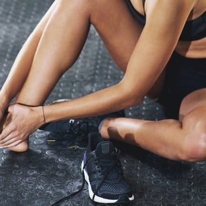 Shot of a sportswoman with an ankle injury.