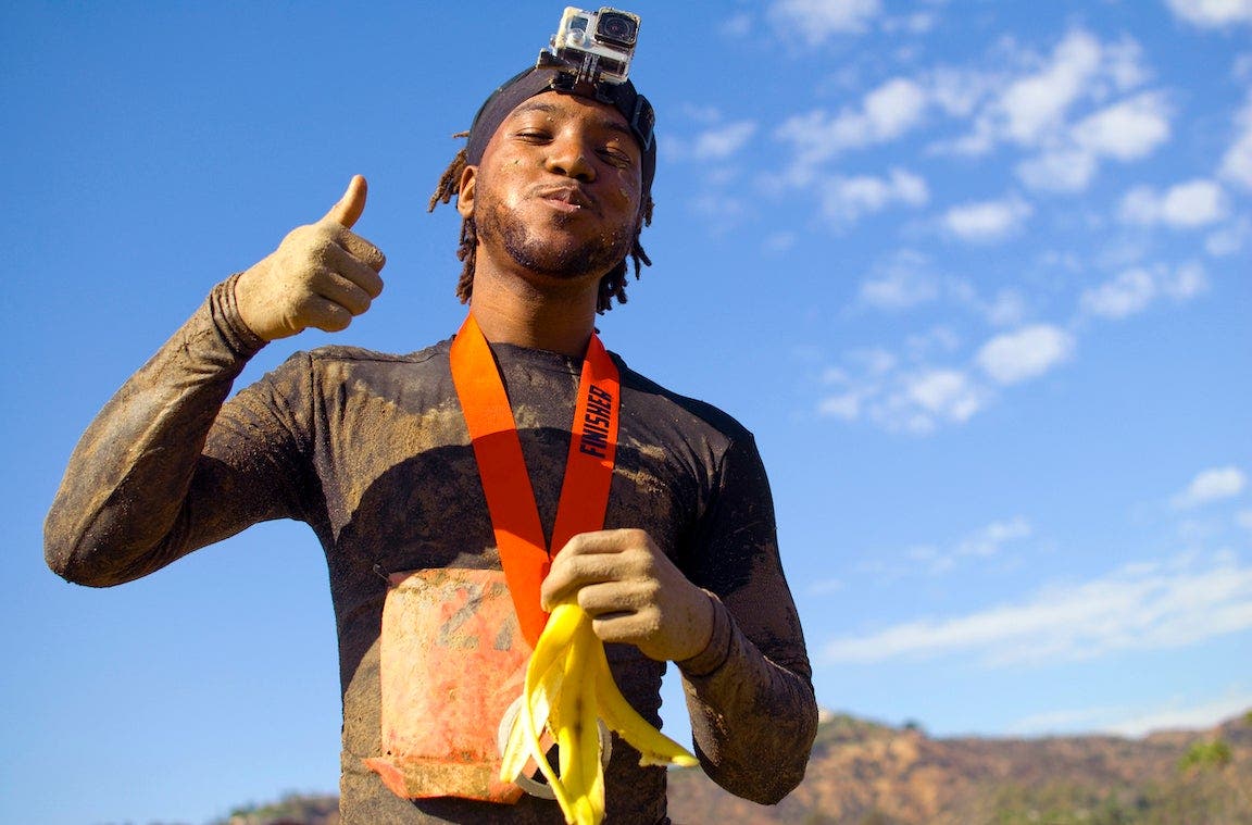 5k competitor at finish of race eating a banana.