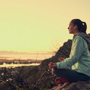 Woman meditating outdoors.