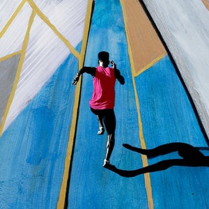 Photographs of athletes at stadium, combined with paint strokes in graphic shapes.