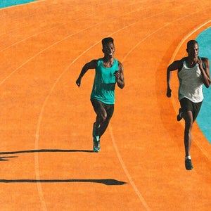 Male runners sprinting on a turquoise and orange track.