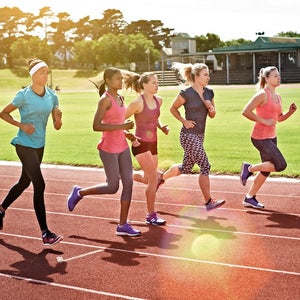 Shot of a group of young athletes out running on the track.