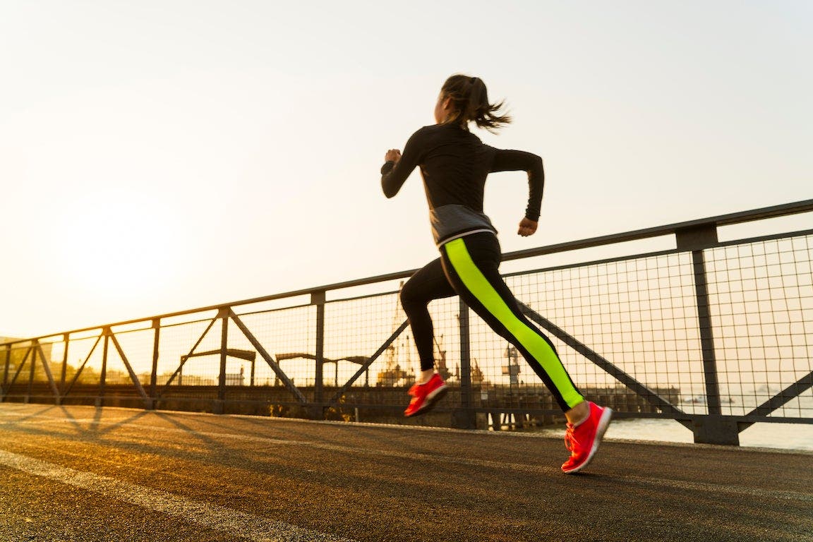 Woman running against twilight sky in China.