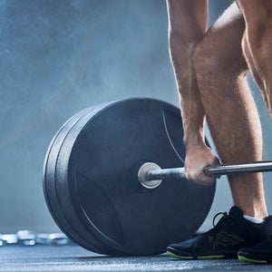 close-up of man doing a deadlift.