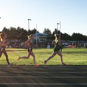 3 high school distance running women in evening meet