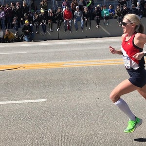 Woman running on road in race.