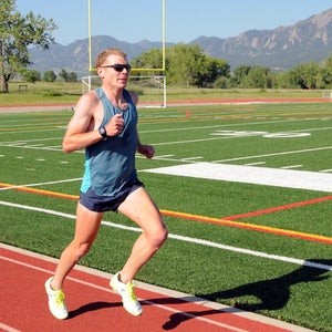 Jake Riley running on track in On shoes.