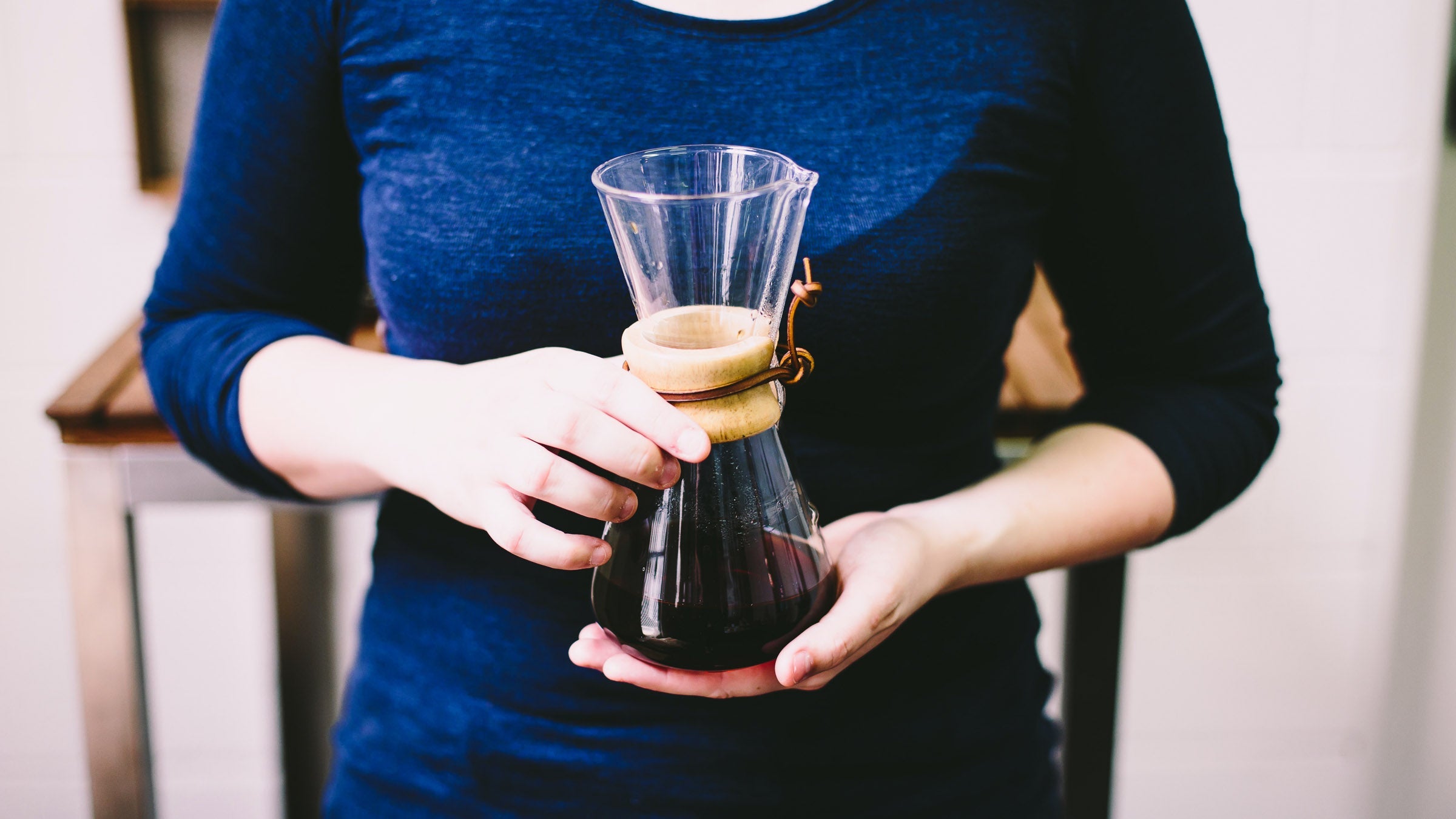 Woman holding carafe of coffee