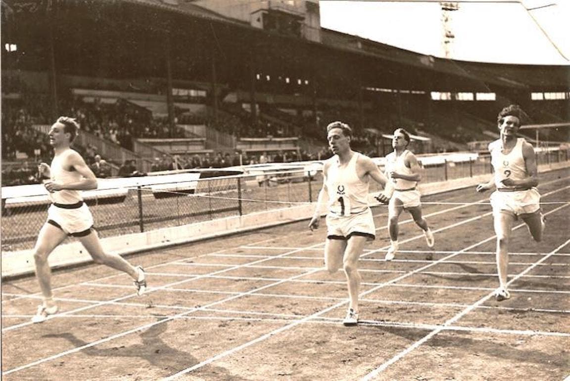 Black and white photo of John Holt racing in the 1960s.
