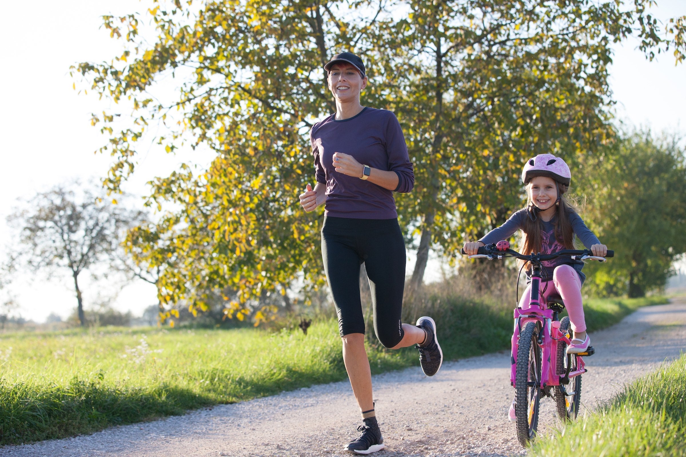 Mother and daughter running outdoors