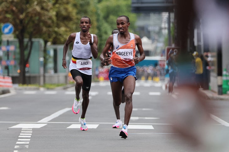 Netherlands' Abdi Nageeye (R) runs to second place ahead of third-placed Belgium's Bashir Abdi in the men's marathon final during the Tokyo 2020 Olympic Games in Sapporo on August 8, 2021.