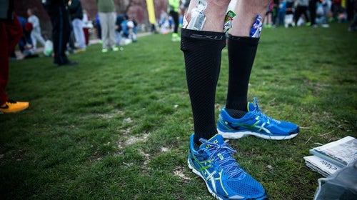 A runner tucks gel packets at the Boston Marathon.