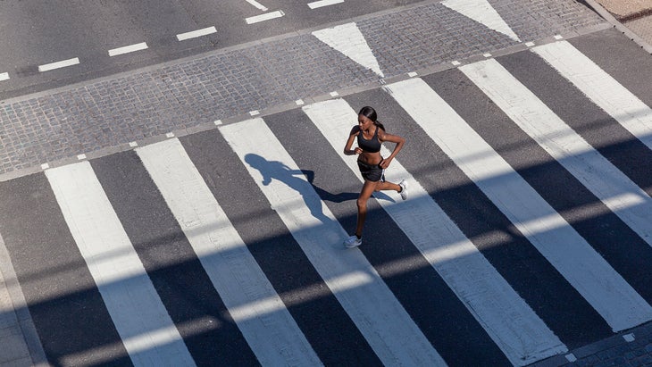 Young woman running on crossing