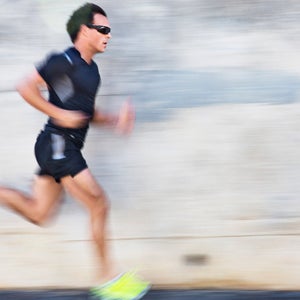 Male athlete running with motion blur