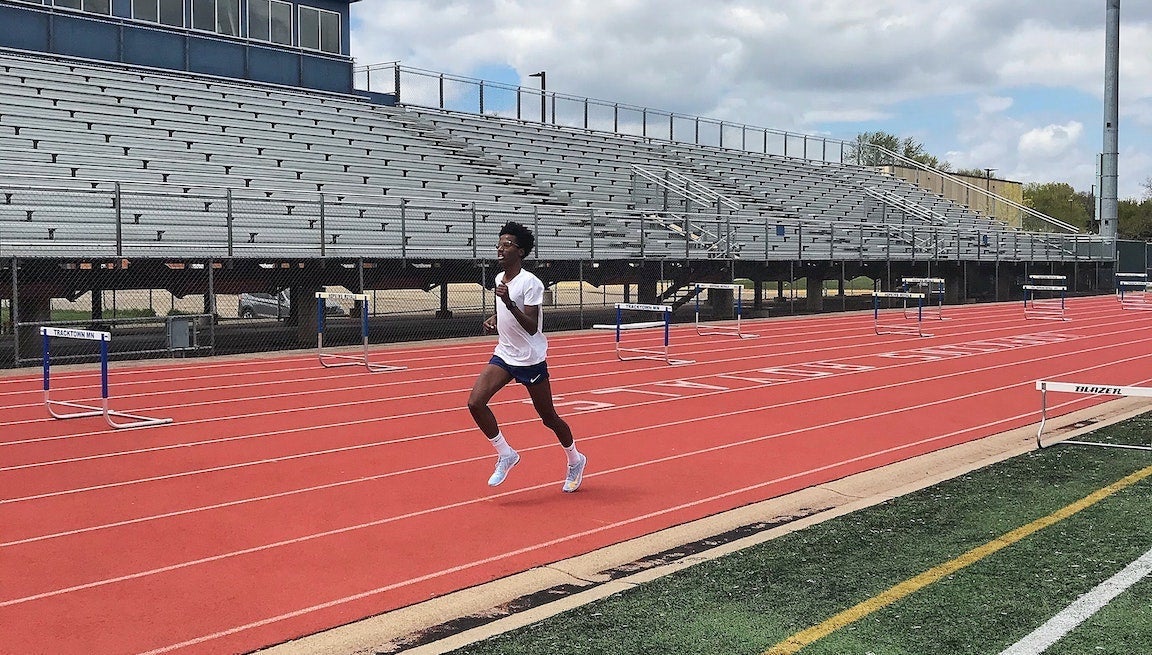 Man running on 400m track.
