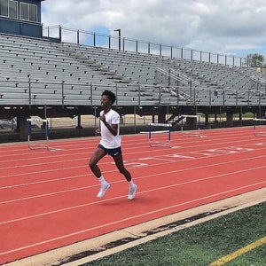Man running on 400m track.