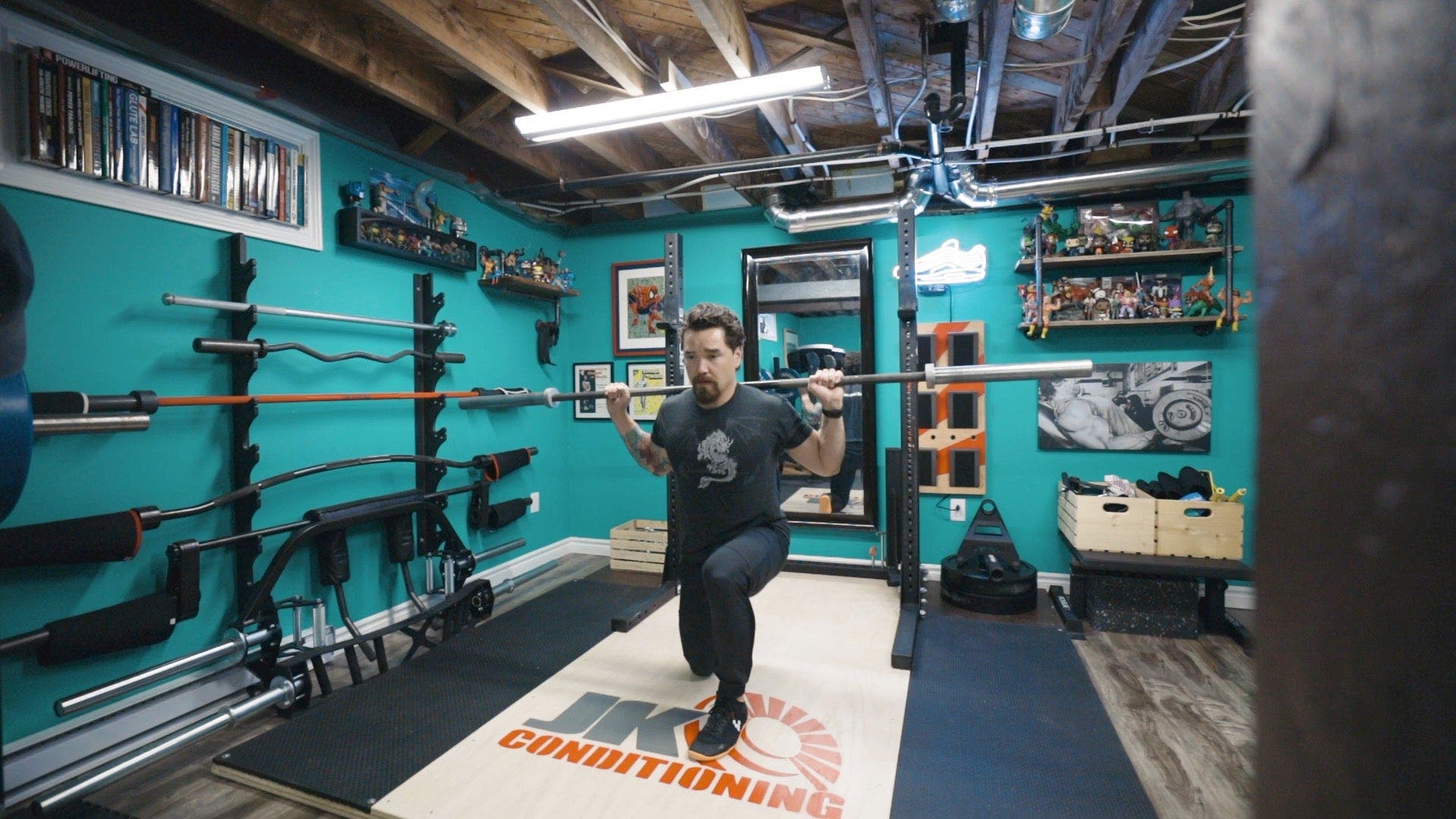 Man lunging with barbell behind shoulders.